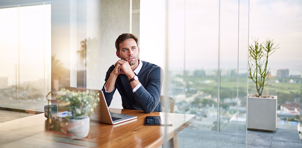 Young entrepreneur deep in thought while working at home