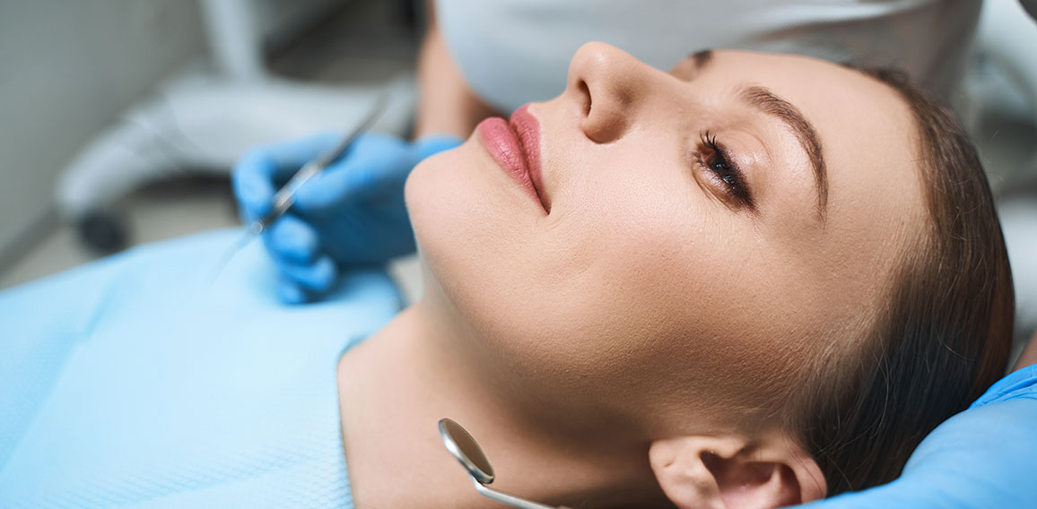 Relaxed young female at dentist stock photo