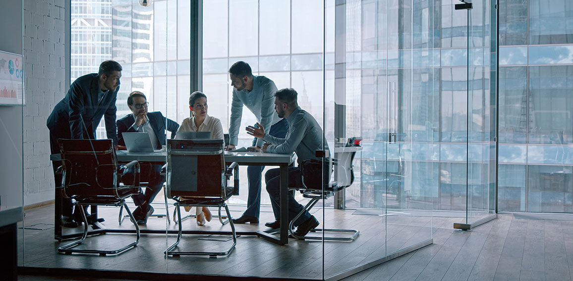 Group of business people working with technology at a meeting in a conference room