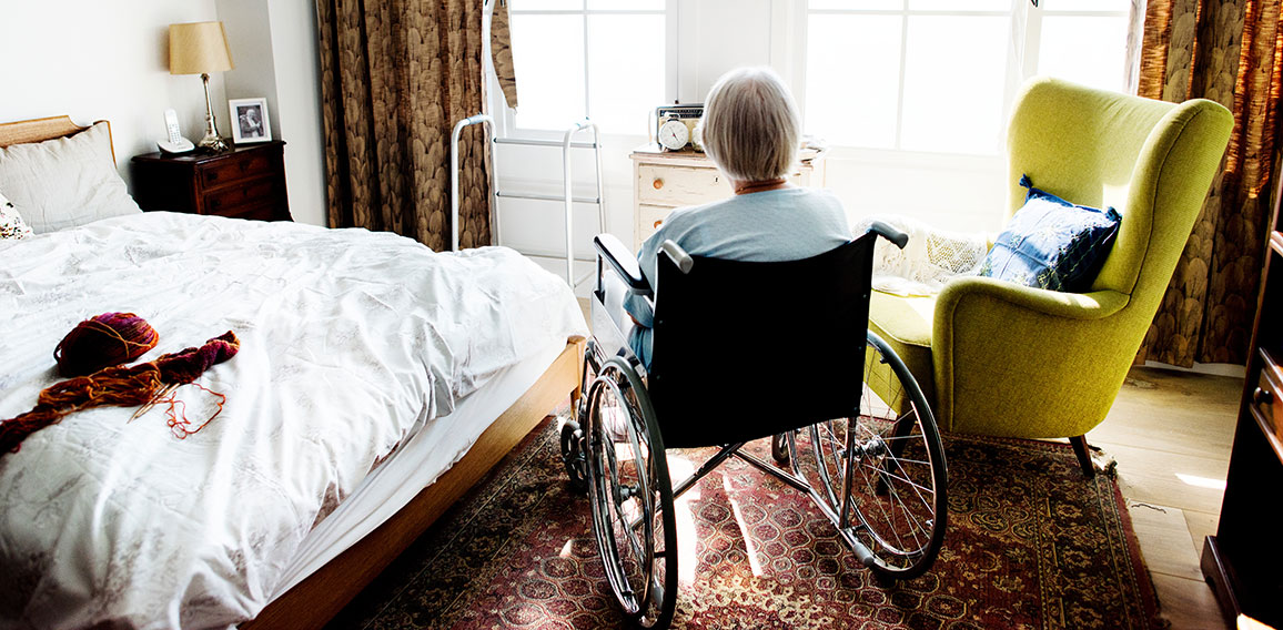 Senior woman sitting on the wheelchair alone