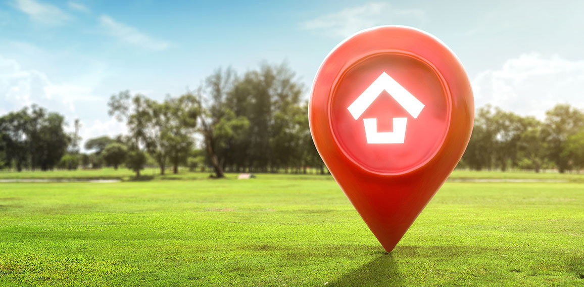 House symbol with location pin icon on earth and green grass in