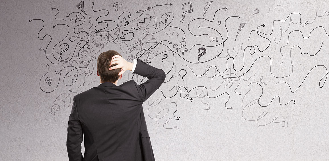 Pensive businessman with abstract arrows sketch on concrete wall background. Confusion and direction concept.