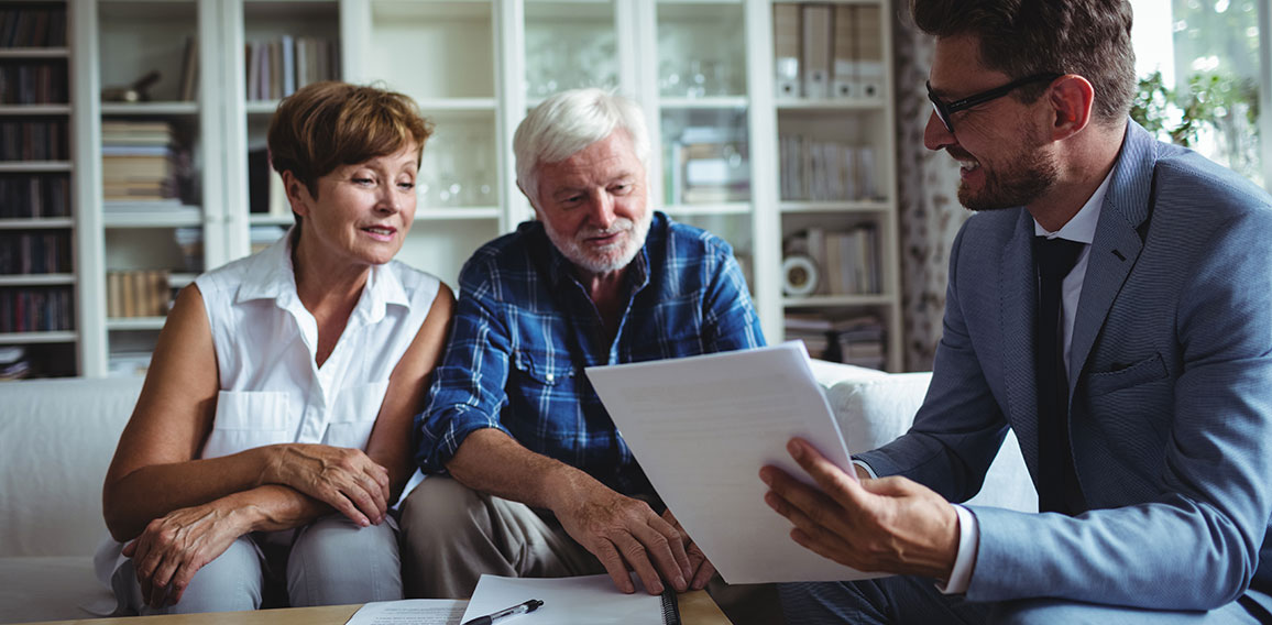 Senior couple planning their investments with financial advisor