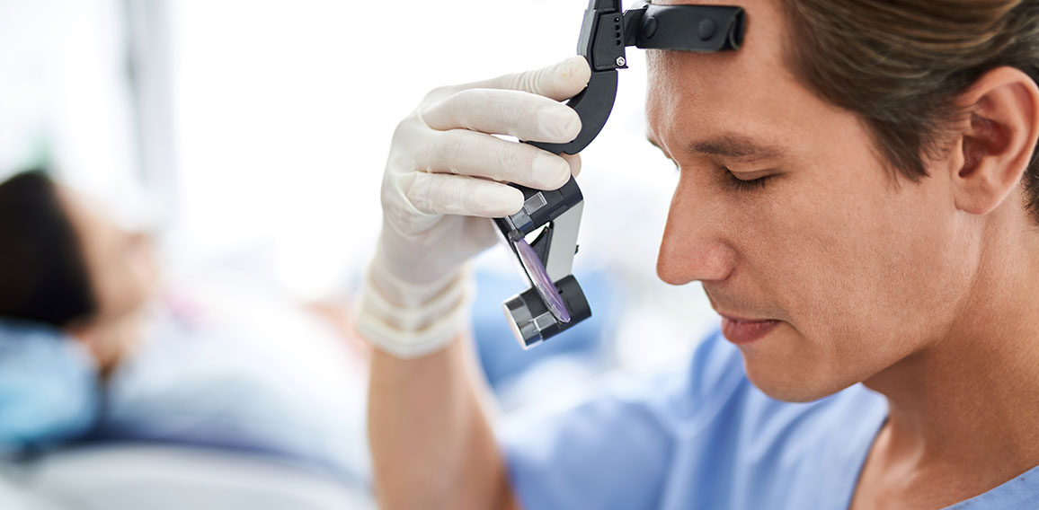 Focused dentist with closed eyes preparing for dental procedure