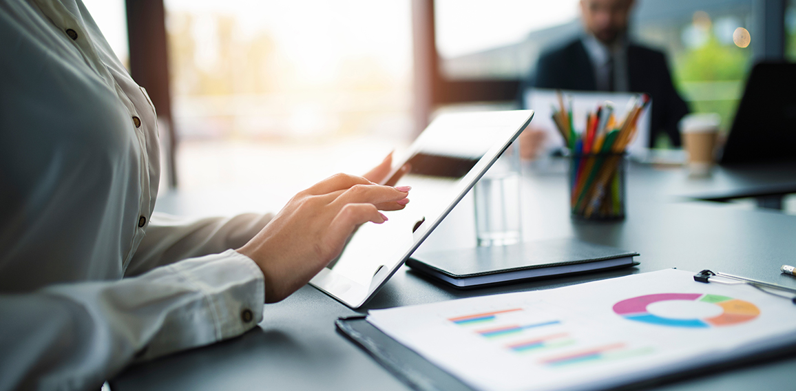 Businesswoman works in office with a tablet.