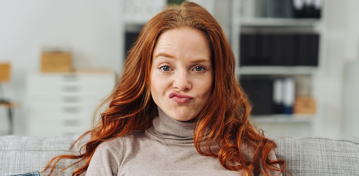 Pretty young redhead woman pulling a face