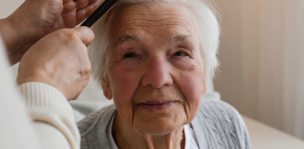 Unrecognizable female expressing care towards an elderly lady, b