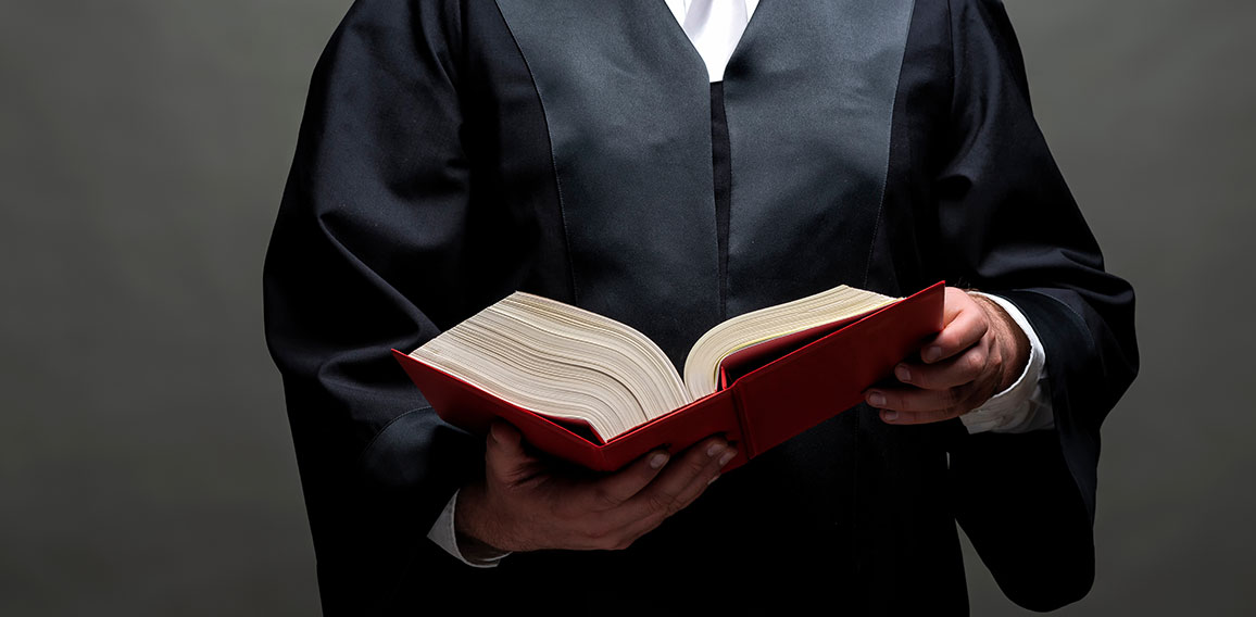 german lawyer with a robe and a book