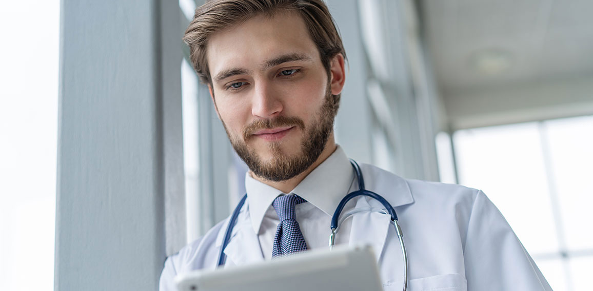 male medical doctor using tablet computer in hospital.