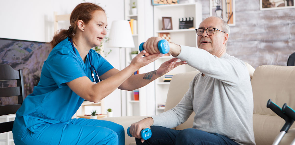 Senior man in nursing home with doing physical therapy