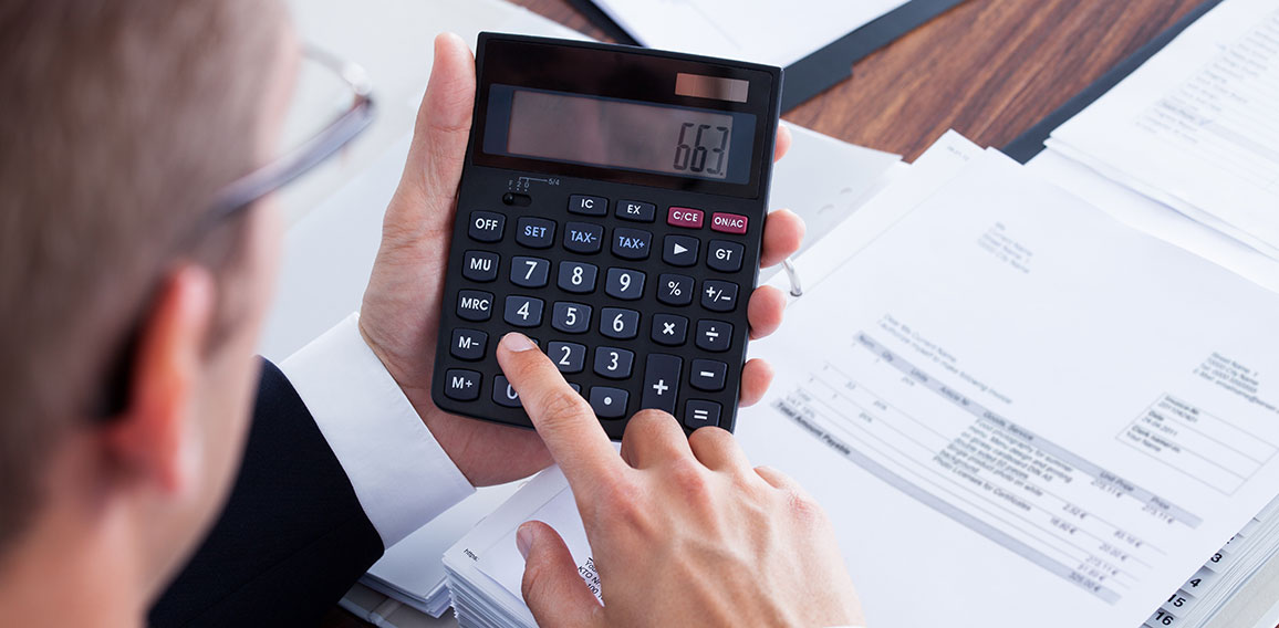 Businessman Using Calculator