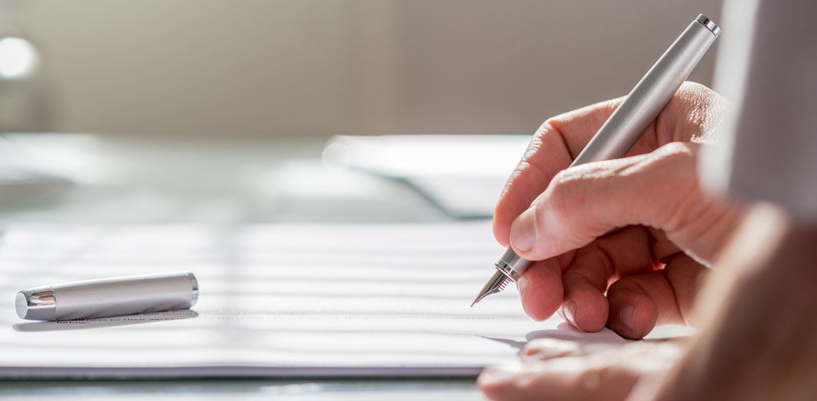 Businessman writing on a document