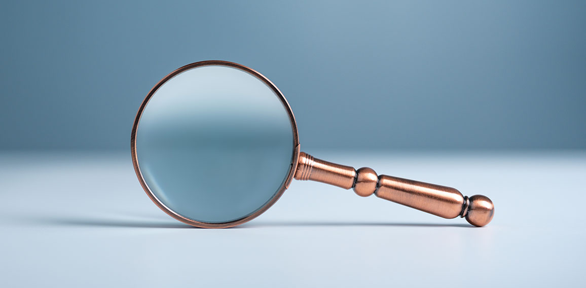 Close up magnifier glass on wooden table, the concept of searching or finding for an idea, Search for information, Find the answer.