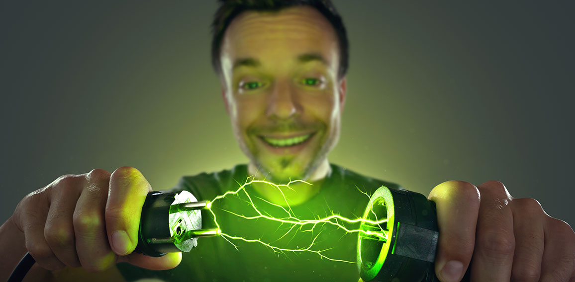 Man connecting green energy power plug