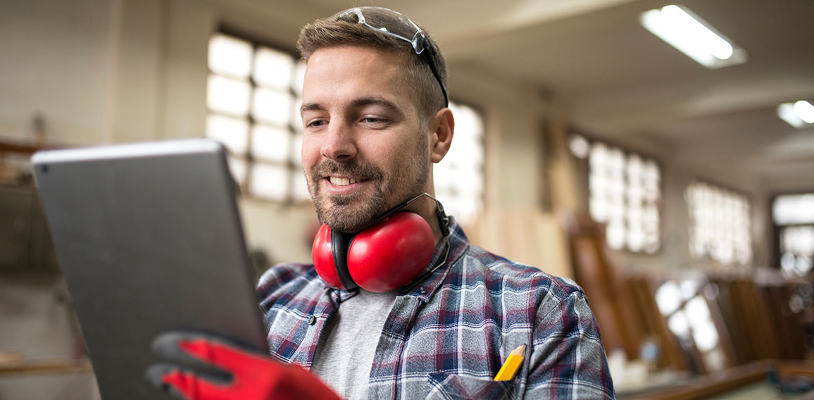 Portrait of middle aged professional worker carpenter with ear p