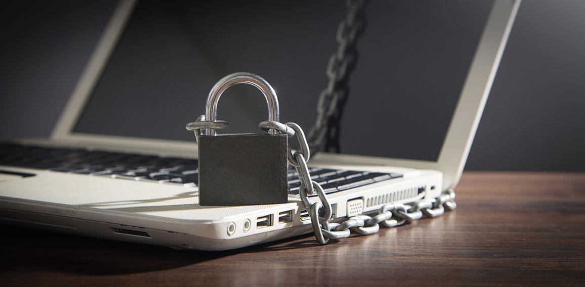 Laptop locked with chains and padlock.