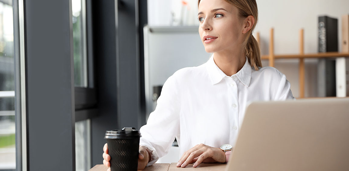 Female business trainer working with laptop in office