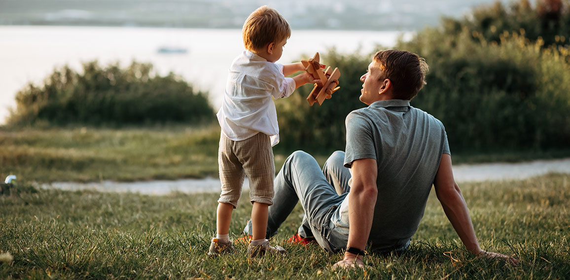 dad and son play on the seashore, vacation with children. Summer adventure, fun trip with kids. Fatherhood, Father's Day. Happy family travel and vacation concept