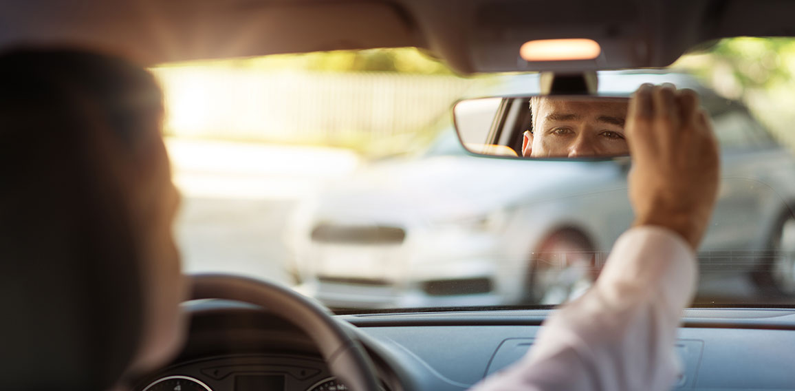 Man adjusting a rearview mirror