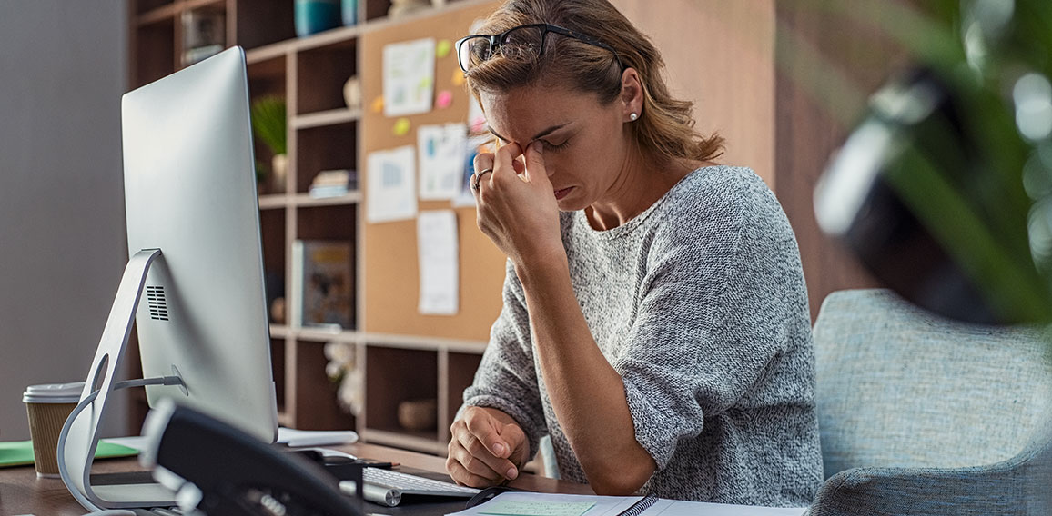 Business woman having headache at office