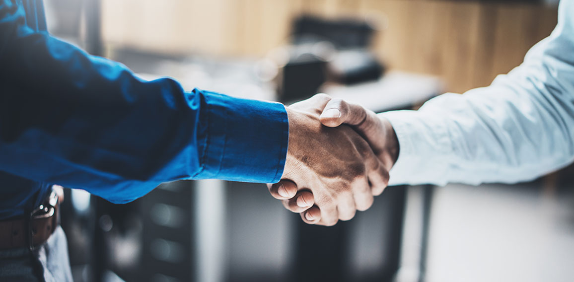 Business partnership handshake concept.Closeup photo of two businessmans handshaking process.Successful deal after great meeting.Horizontal, blurred background.