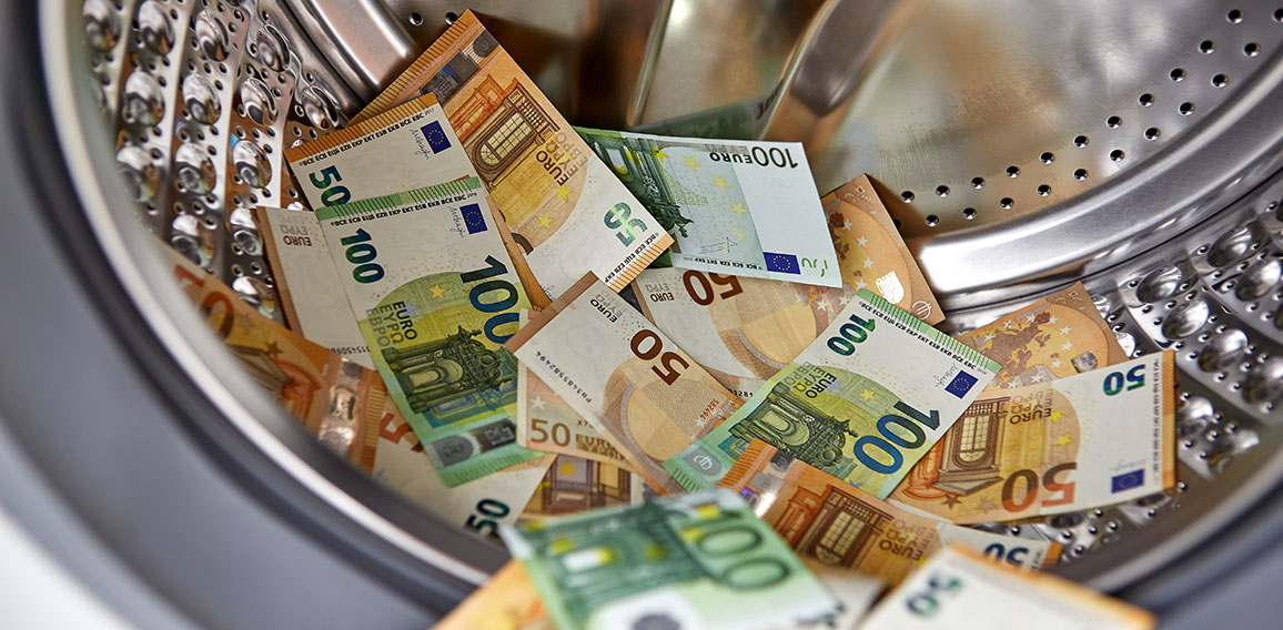 Money laundering concept - euro banknotes in washing machine