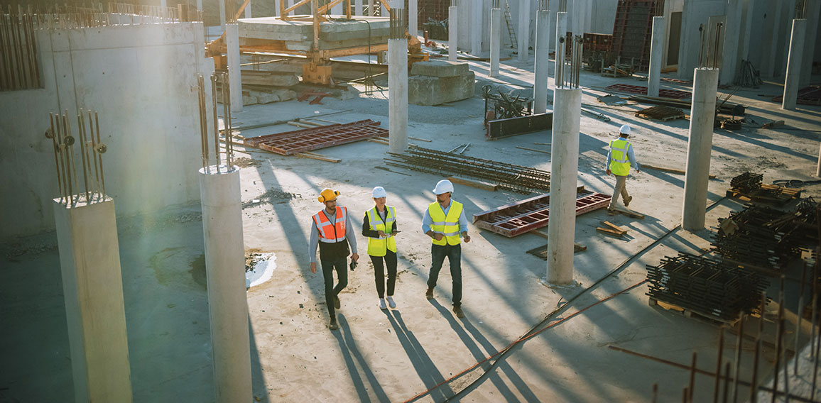 Diverse Team of Specialists Taking a Walk Through Construction S