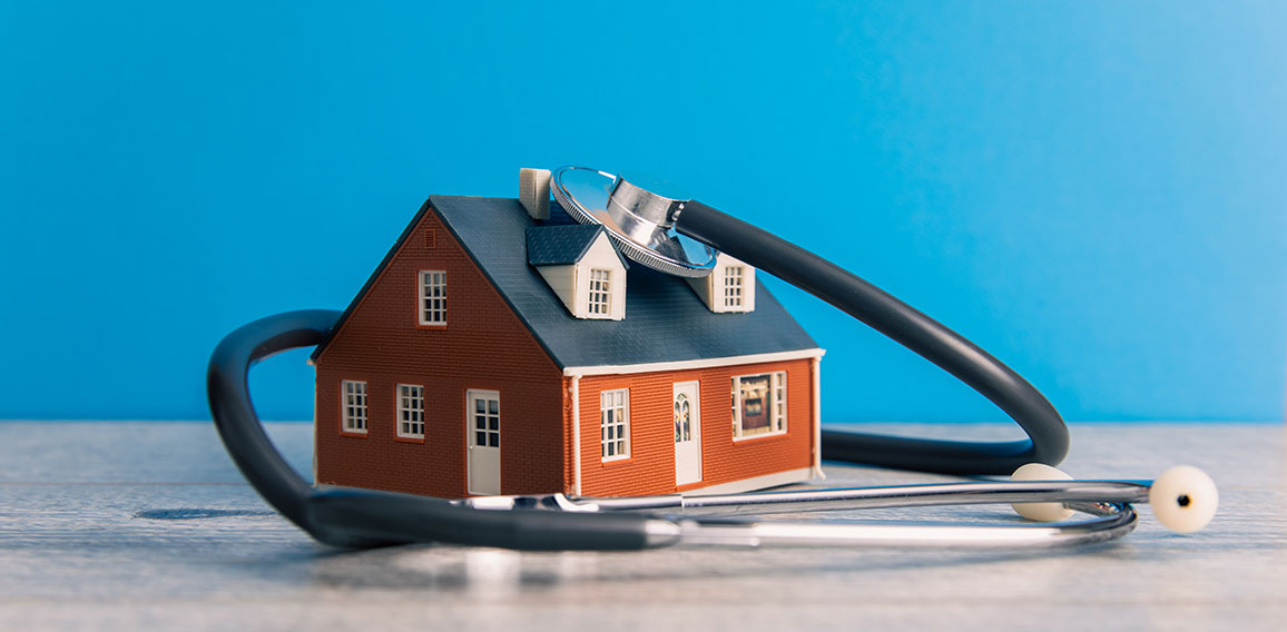 House and Stethoscope on Table