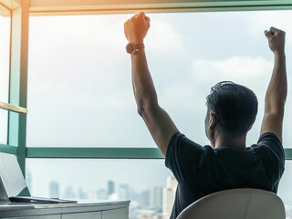 Business achievement concept with happy businessman relaxing in