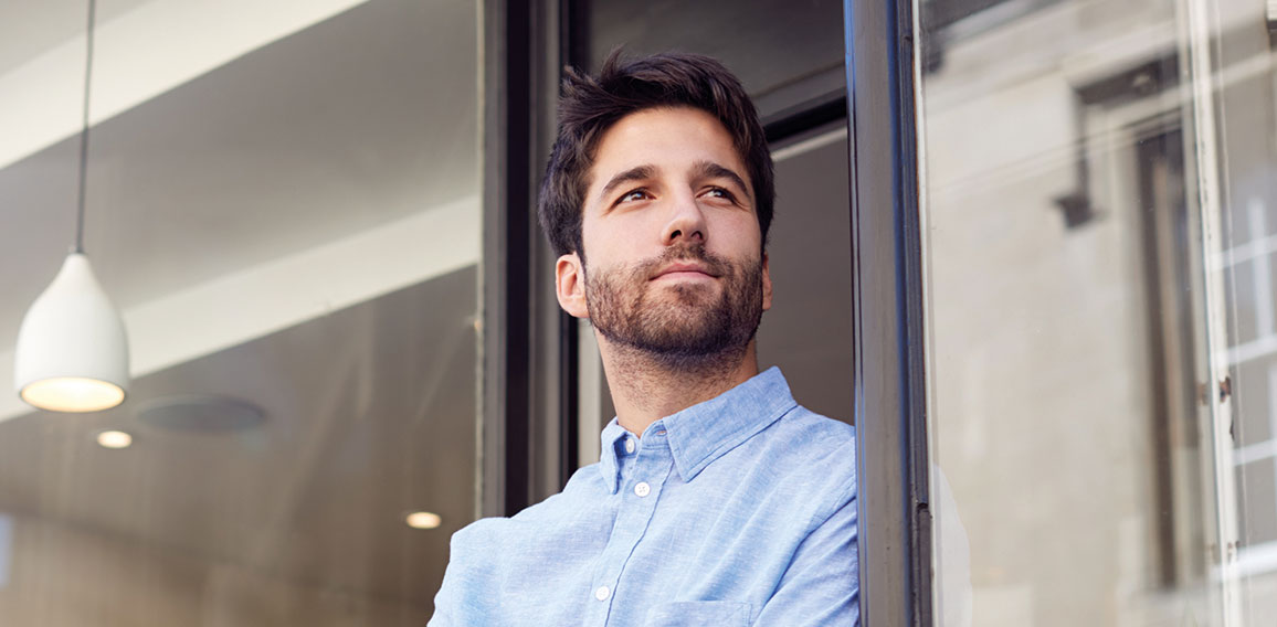 Portrait Of Male Owner Standing Outside Coffee Shop