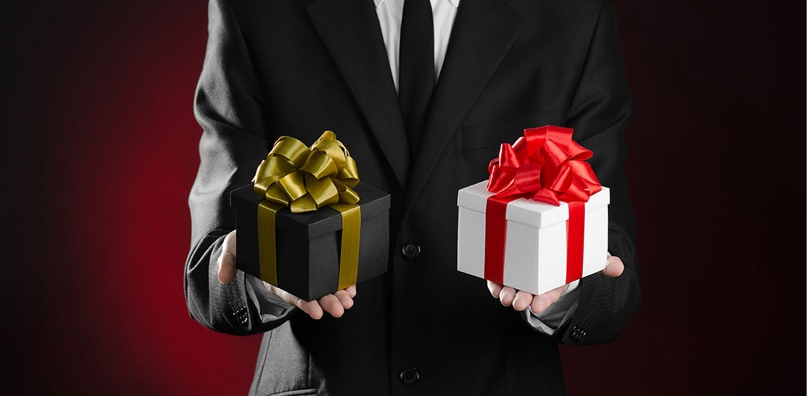 Theme holidays and gifts: a man in a black suit holding two excl