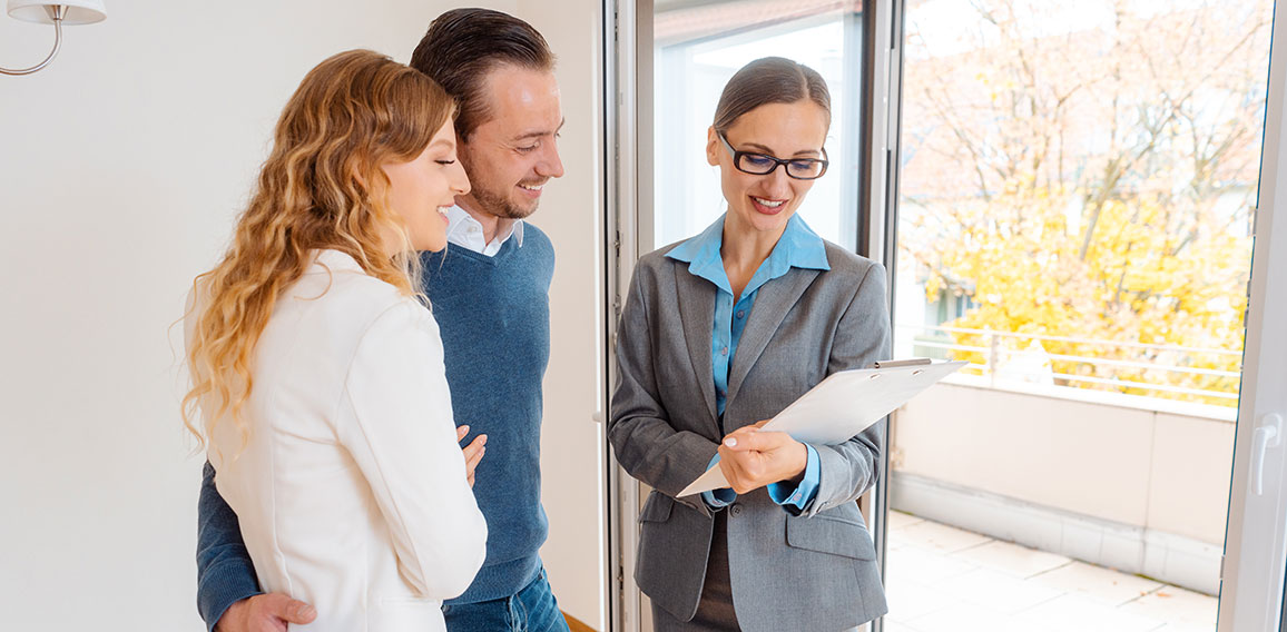 Landlady or realtor showing lease agreement to new tenants