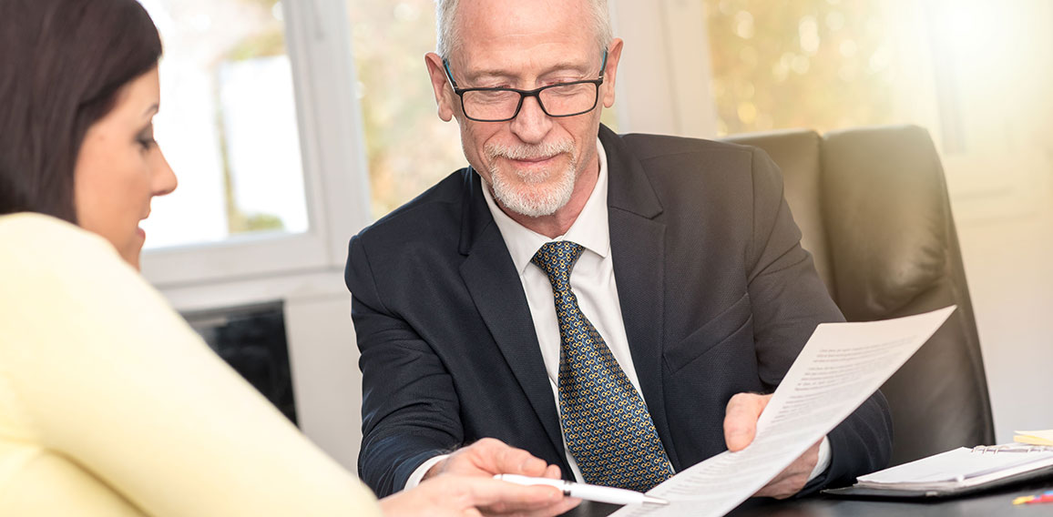 Woman meeting financial adviser in office, light effect