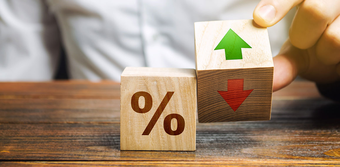 Businessman holds wooden blocks with percent and up or down arrow. Mortgage and loan rates. Interest rate, stocks, ranking. Business and finance concept.