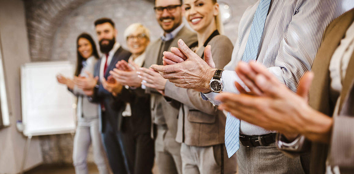 Great job! Successful business team is clapping their hands in m