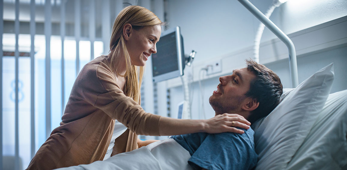 In the Hospital, Happy Wife Visits Her Recovering Husband who is