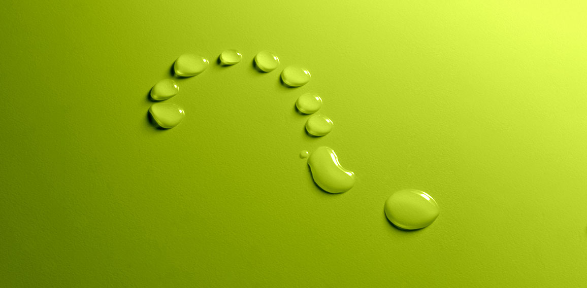 Water drops question mark on green background