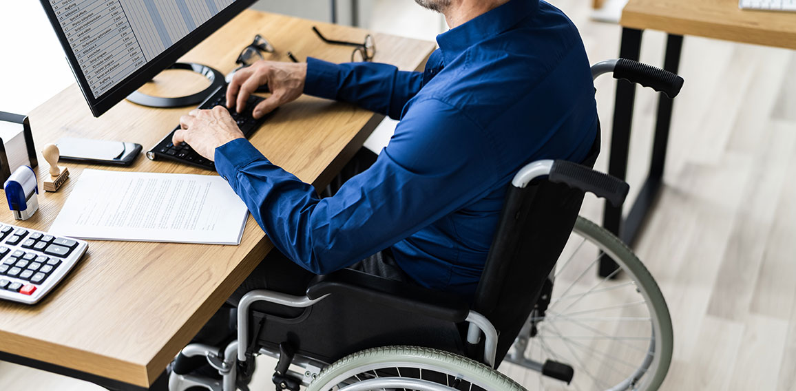 Disabled Handicapped Man In Wheelchair Working