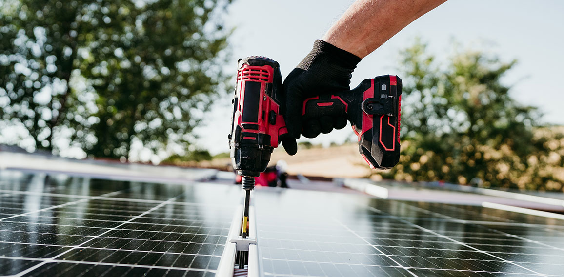 close up hand of mature Technician man assembling solar panels w