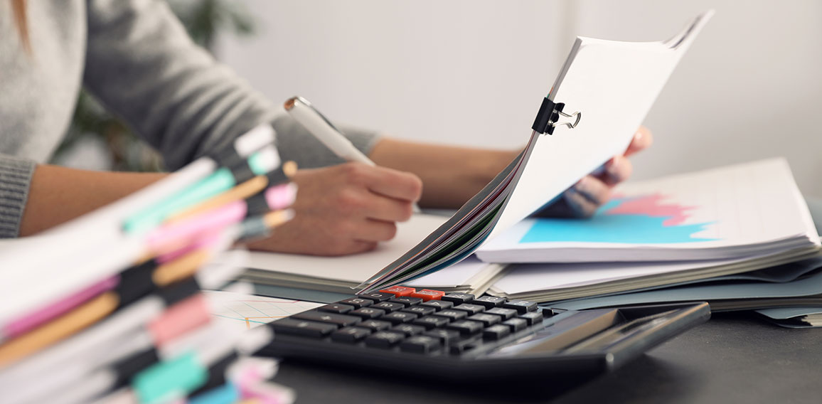 Office employee working with documents at table, closeup