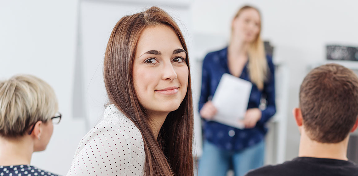 Young woman in a lecture turning to camera