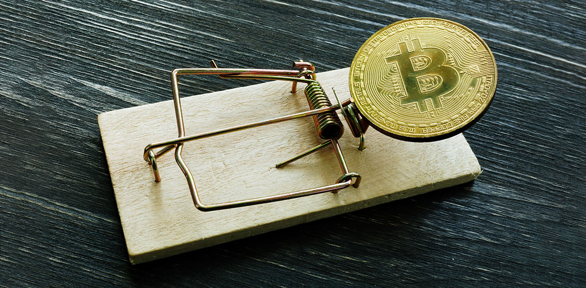 Mousetrap and bitcoin coin. Cryptocurrency scam or fraud concept.