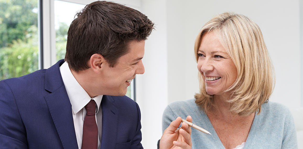 Mature Woman Meeting With Financial Advisor At Home