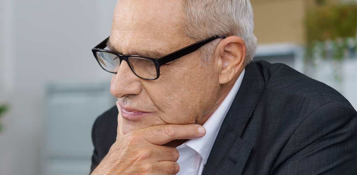 Boss thinking while coworker sits on table