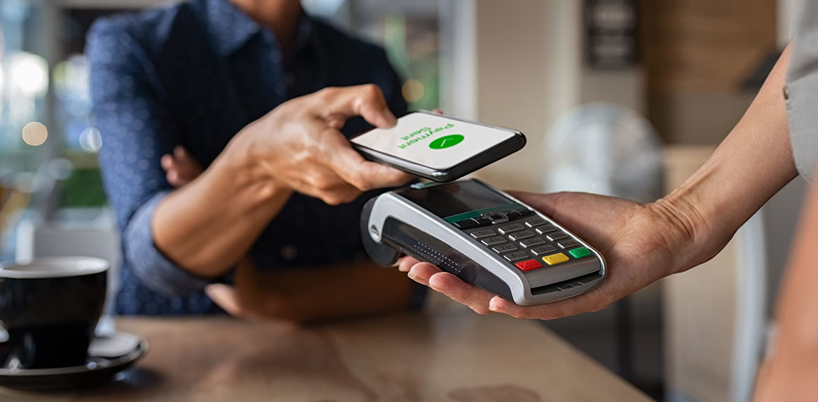 Woman paying using NFC technology