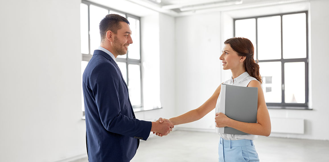 businesswoman and businessman shake hands