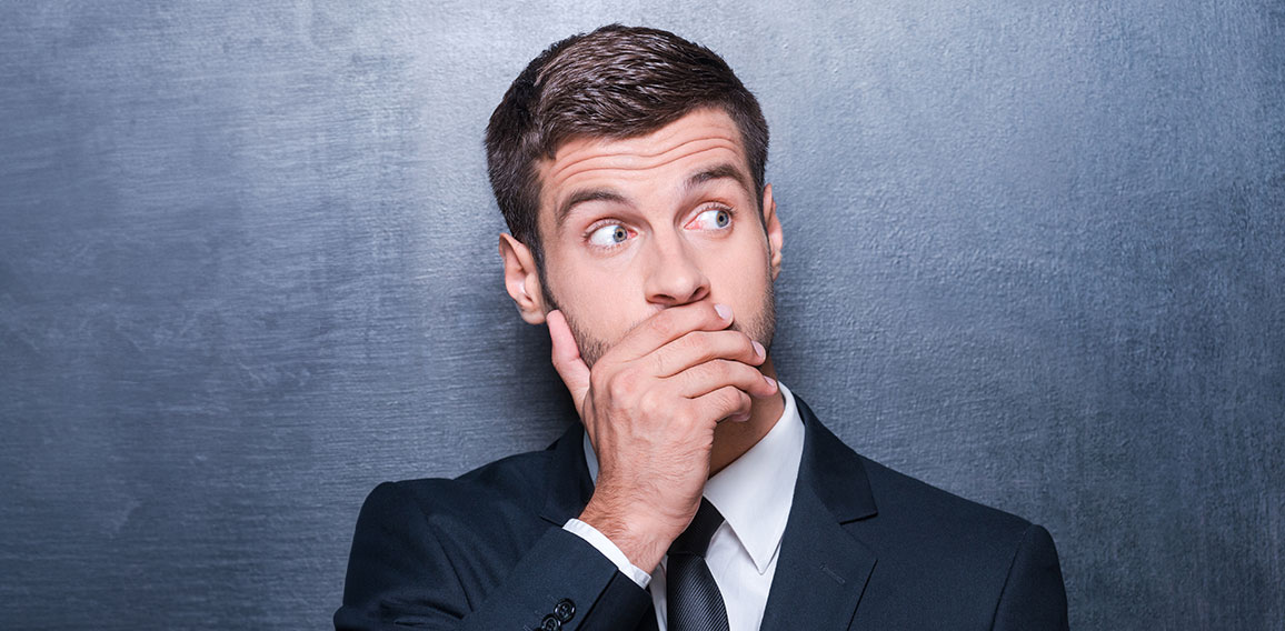 No way! Shocked young man in formalwear covering mouth with hand