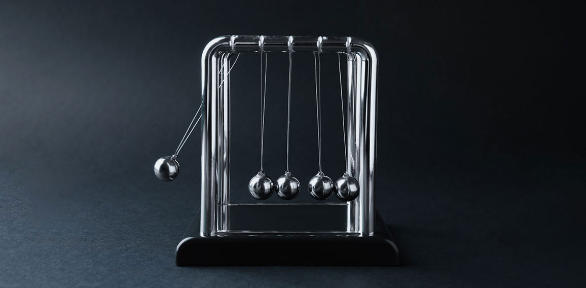 Newton's cradle on dark background. Physics law of energy conser