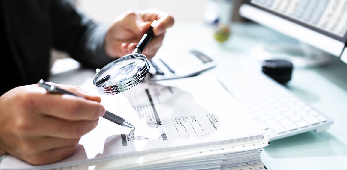 Audit And Fraud Investigation. Auditor Using Magnifying Glass