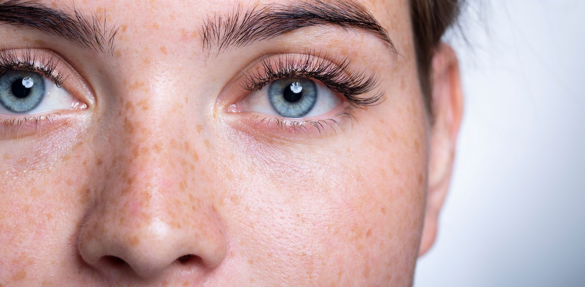 A close up of a person with blue eyes looking at the camera